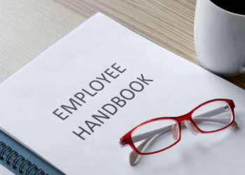 employee handbook with red glasses sitting on top